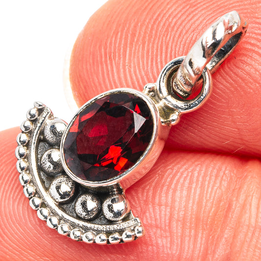Garnet oval pendant in .925 sterling silver with decorative bezel and loop bail