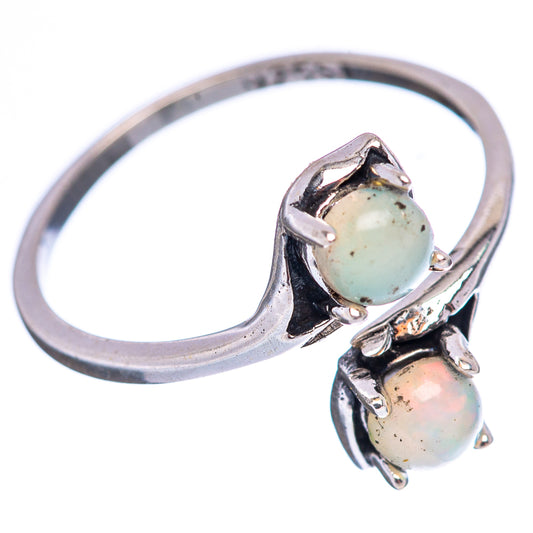 Sterling silver opal ring, rounded band with two cabochon stones and scalloped prongs
