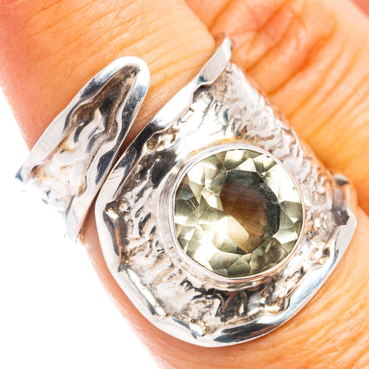 Sterling silver adjustable ring with oval green gemstone in ornate bezel setting