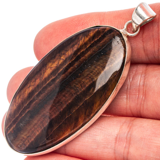 Tiger's eye pendant with silver-plated oval stone, striped brown and gold, loop bail.