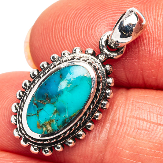 Turquoise oval pendant stone in ornate .925 sterling silver setting.