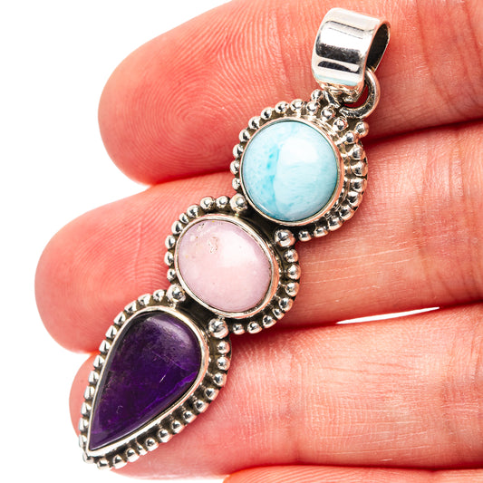 Sterling silver pendant with blue, pink, and purple gemstones in bezel settings