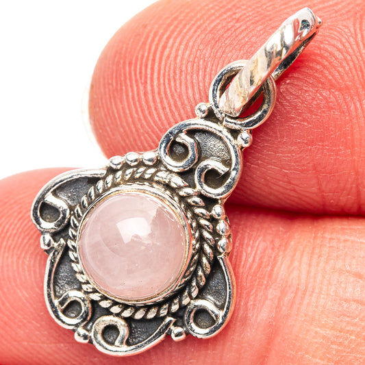 Rose quartz pendant in .925 sterling silver with ornate round pink stone setting