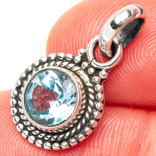 Sterling silver pendant with blue topaz oval set in ornate round bezel