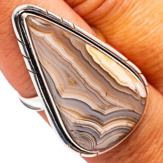 Crazy lace agate teardrop ring in polished .925 sterling silver, worn on finger