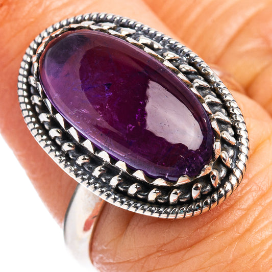 Sterling silver amethyst ring close-up: oval purple stone in detailed rope-like setting