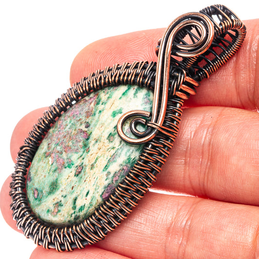Oxidized copper teardrop wire-wrapped pendant with green-blue speckled stone and bail