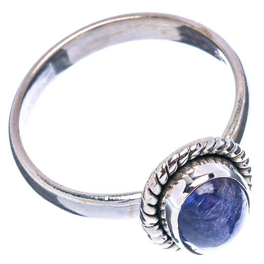 Sterling silver ring band with oval blue-purple gemstone and raised ornate setting