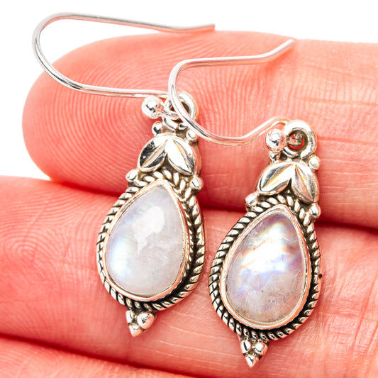 Sterling silver moonstone teardrop earrings with ornate bead border and rainbow shimmer