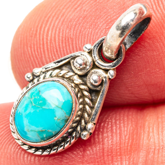 Turquoise oval pendant in ornate .925 sterling silver setting with round bail
