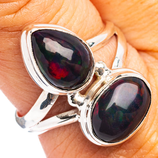 Sterling silver opal ring with two oval black-red cabochon stones, open bypass setting