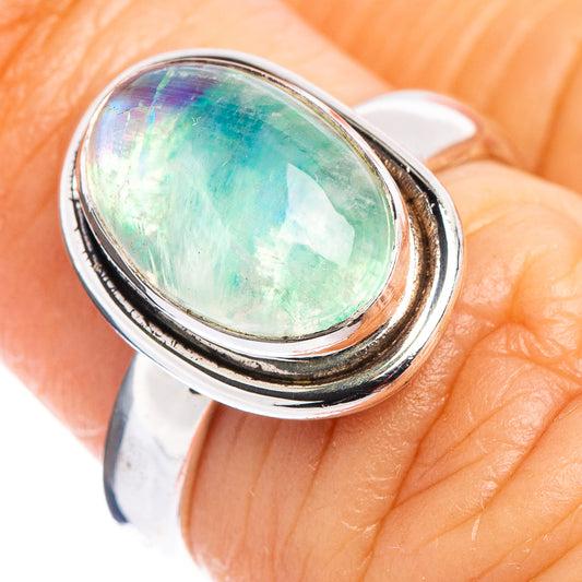 Green moonstone oval sterling silver ring on finger, size 6