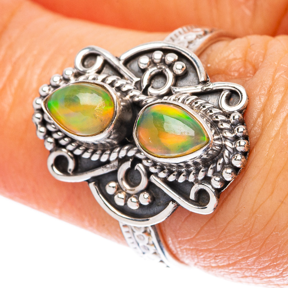 Sterling silver opal ring with two oval cabochon stones, green and orange glow