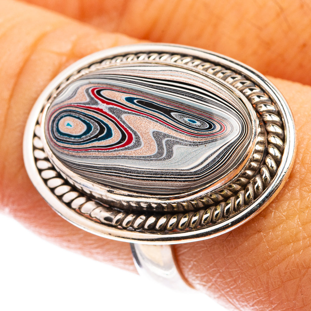 Oval sterling silver fordite ring with multicolor swirl stone and beaded bezel detail