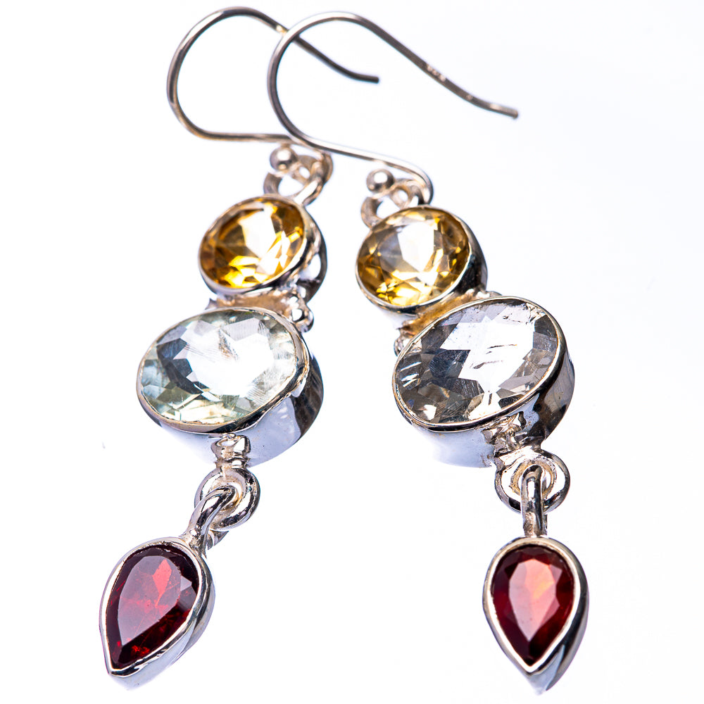 Pair of silver dangle earrings with round yellow stones, clear heart stones, and red teardrops