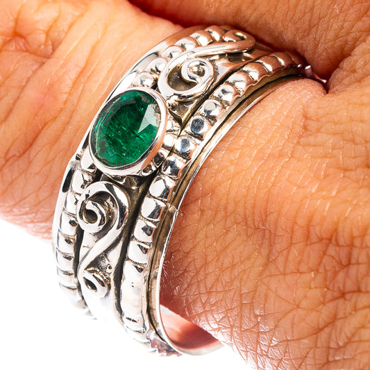 Sterling silver ring with oval green gemstone and ornate carved band