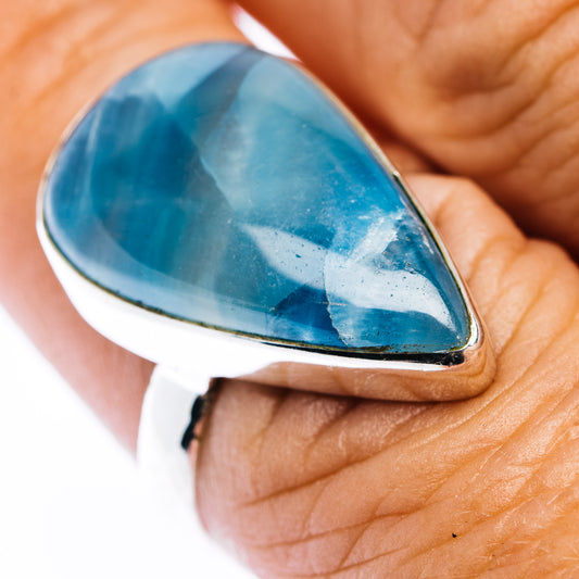 Sterling silver teardrop ring with blue aquatine-style gemstone cabochon.