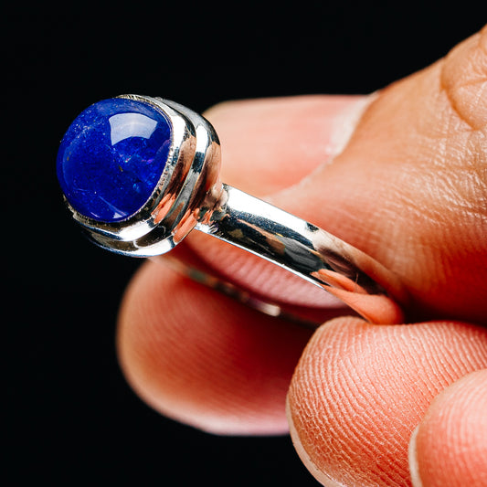 Sterling silver tanzanite ring with blue oval cabochon and polished band