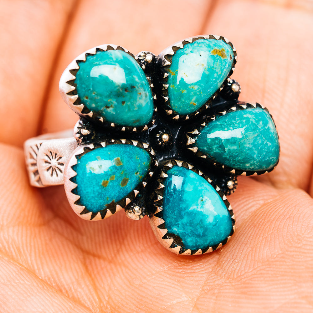 Turquoise oval cluster ring on silver band with black accents