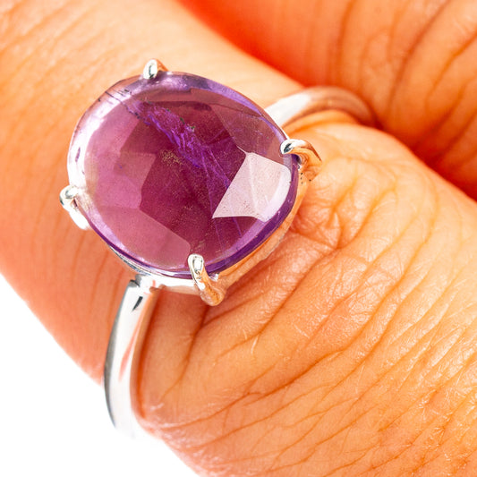 Amethyst gemstone ring with faceted oval stone and silver prongs on band