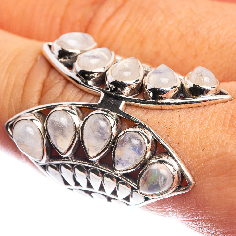 Silver moonstone ring with oval opal-like stones in curved prong settings