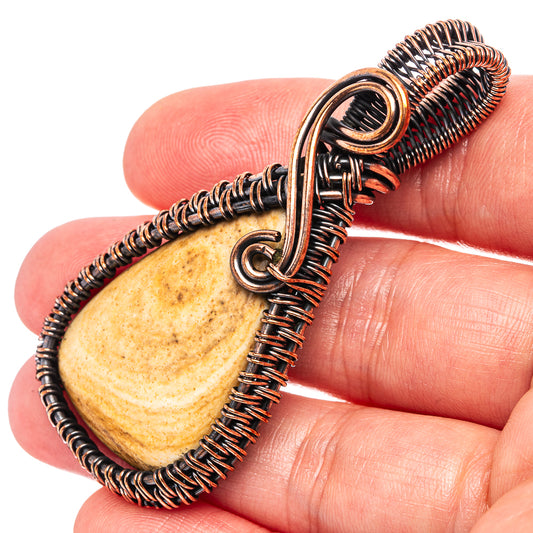 Oxidized copper wire wrap pendant close-up, teardrop jasper with loop bail and coiled wire
