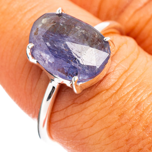 Sterling silver ring with faceted oval blue-purple gemstone and prongs