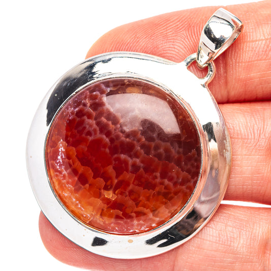 Round fire crab agate pendant set in .925 sterling silver bezel with lobster clasp bail