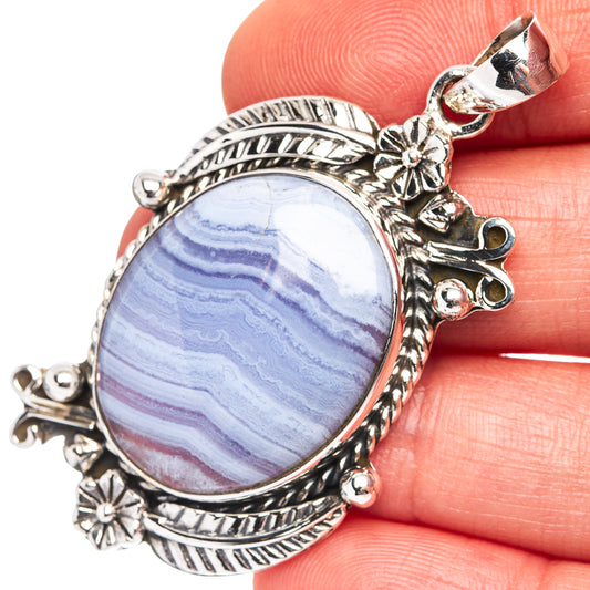 Sterling silver oval lace agate pendant with blue and white banded stone setting