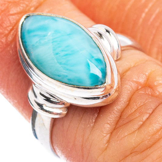Sterling silver ring featuring oval turquoise larimar cabochon and curved metal bezel