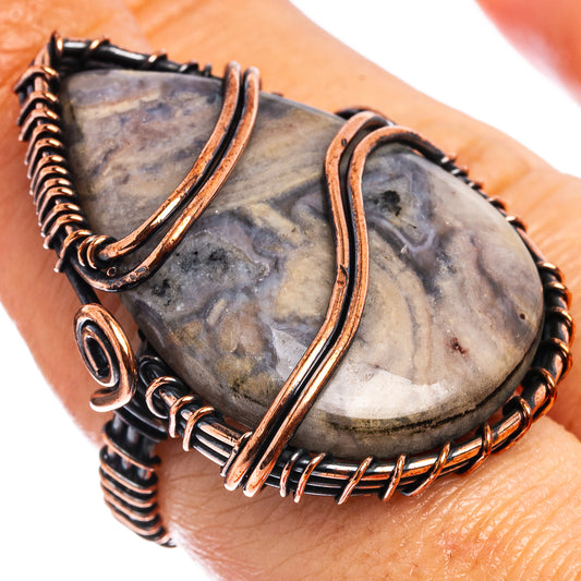 Oxidized copper wire-wrap ring with teardrop stone, spiraled wire and open loop details