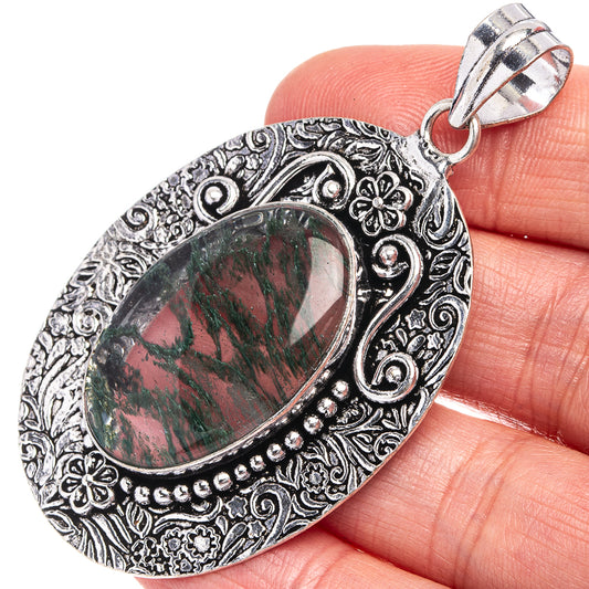 German silver moss agate oval pendant, filigree bezel and split bail; green-red cabochon