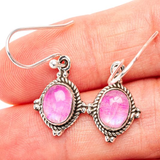 Pink oval moonstone drop earrings with ornate silver-tone bezel and teardrop hooks