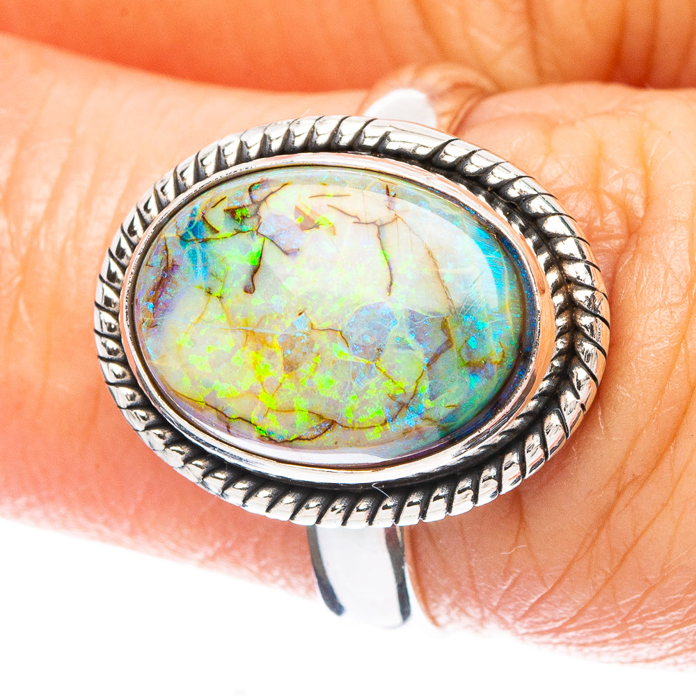 Oval opal ring with rope-style silver band, green-blue iridescent center
