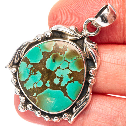 Oval turquoise cabochon pendant with ornate .925 sterling silver border and top bail