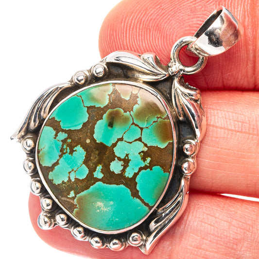 Oval turquoise cabochon pendant with ornate .925 sterling silver border and top bail