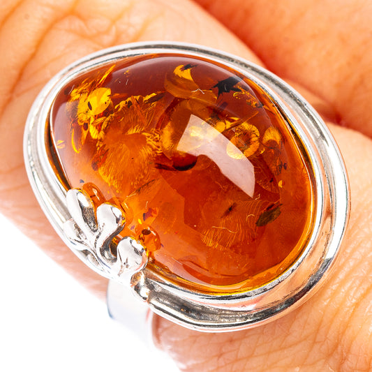 Oval amber stone ring with leaf inclusions in .925 sterling silver setting