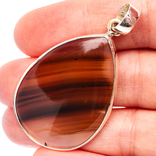 Teardrop agate pendant in .925 sterling silver with amber-brown stone bezel