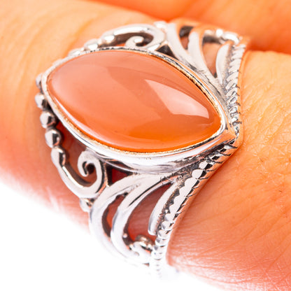 Sterling silver ring with oval peach moonstone and ornate filigree setting