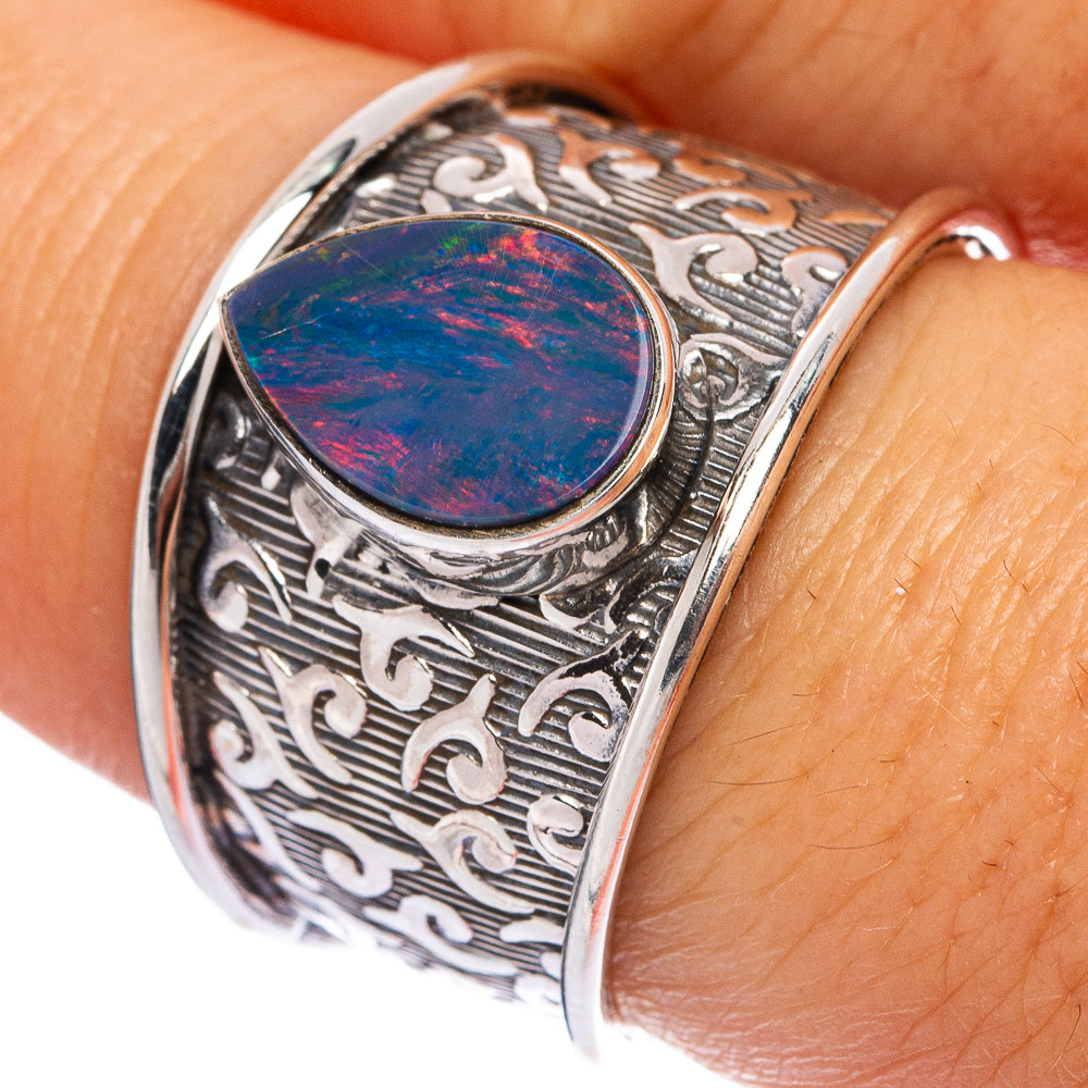 Sterling silver ring with round fire opal cabochon and ornate scroll engraving