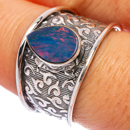 Sterling silver ring with round fire opal cabochon and ornate scroll engraving