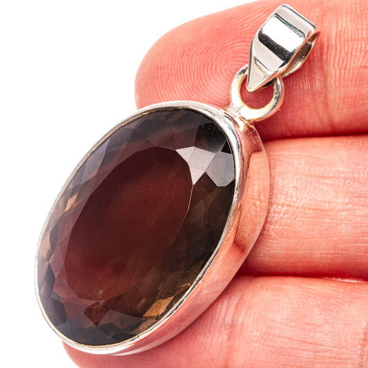 Smoky quartz oval pendant in .925 sterling silver with faceted dark gemstone bezel