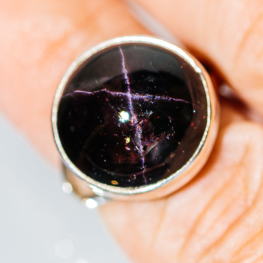 Round star garnet cabochon set in .925 sterling silver ring, close-up