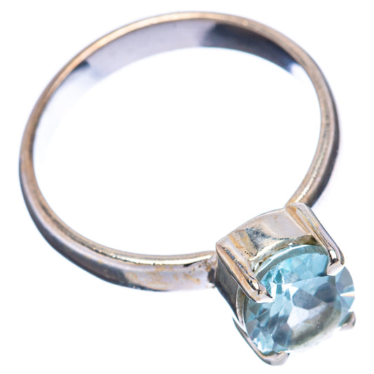 Sterling silver band ring with faceted blue topaz stone in corner prongs