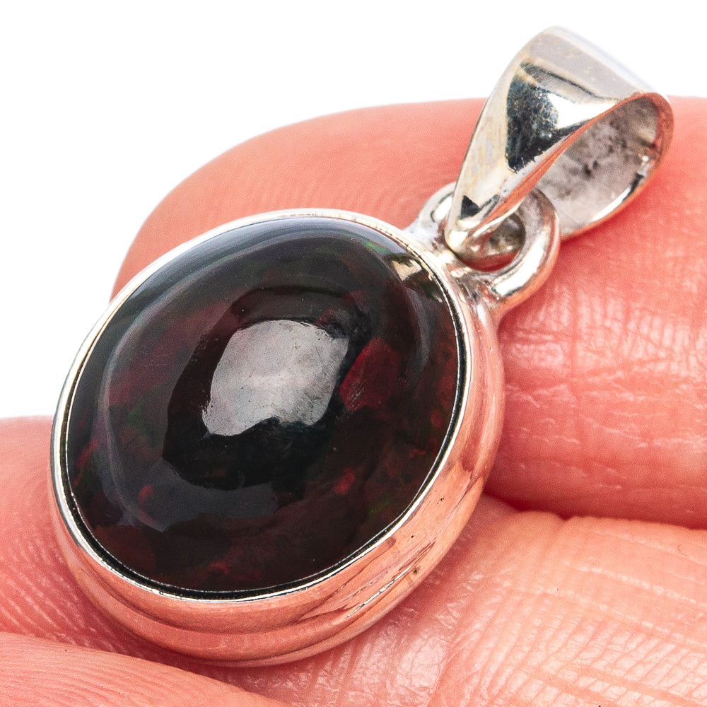 Oval black opal pendant in polished 925 sterling silver bezel with bail