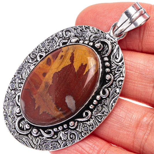 Mookaite oval pendant with marbled red-brown stone and ornate German-silver frame