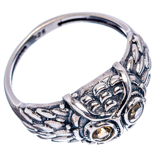 Sterling silver owl ring with side band details and a round citrine-colored gemstone
