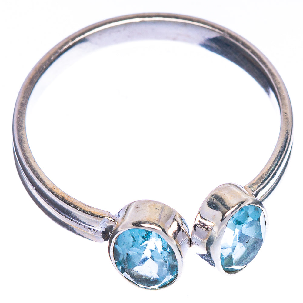 Sterling silver ring with two oval blue topaz prong settings on a curved band