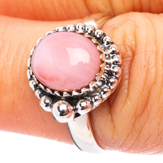 Sterling silver ring with pink oval opal center and beaded halo setting