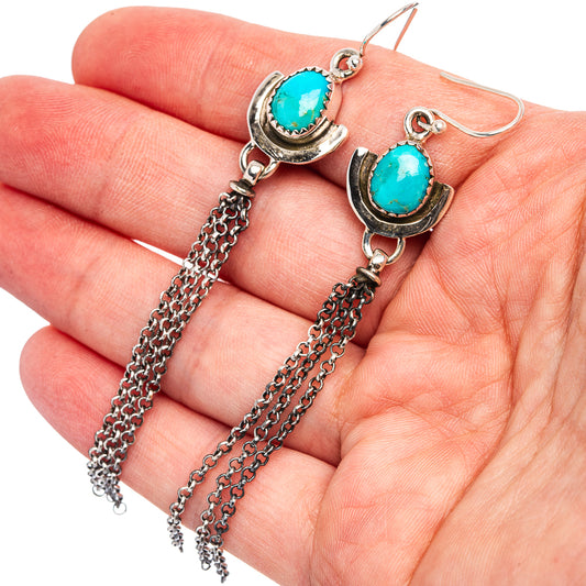 Turquoise oval drop earrings with silver-tone bezel and dangling chain tassels